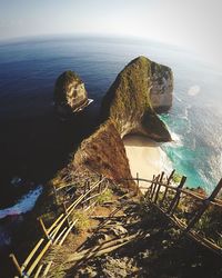 High angle view of rocks by sea against sky