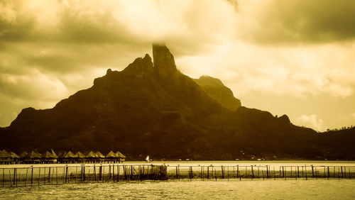 Scenic view of lake by mountains against sky