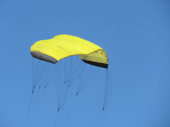 Low angle view of parachute against clear sky