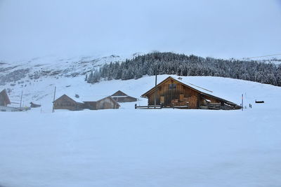 Cottages at the swiss alps of the jungfrau region with snow in winter. view from the running train.