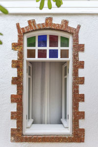 Close-up of window on white wall of building