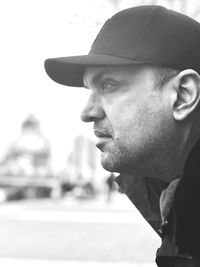 Close-up of man wearing cap looking away