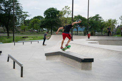 Rear view of man skateboarding on skateboard park