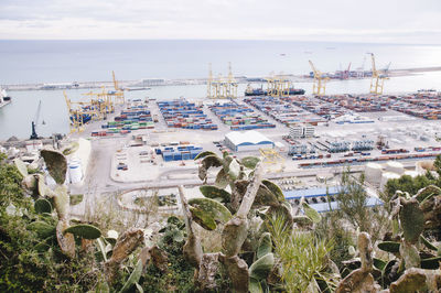 High angle view of buildings by sea against sky