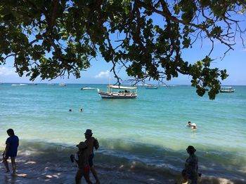 People on beach against sky