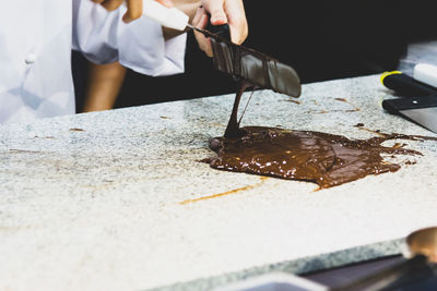 Midsection of man working on table