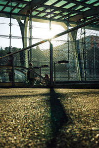 Shadow of man on bridge in city