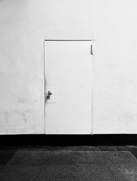 White wall and closed door of building