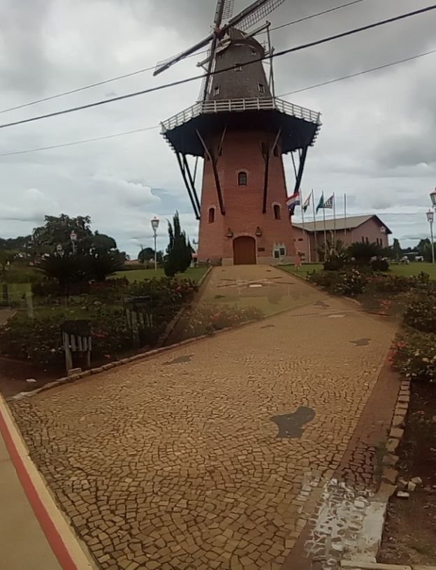 TRADITIONAL WINDMILL BY TREE AGAINST SKY