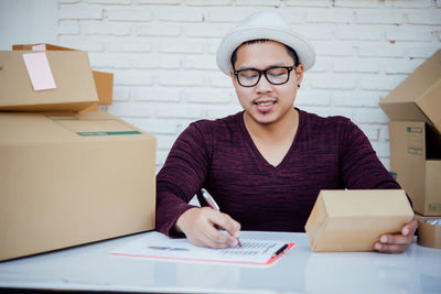 Portrait of mature man sitting on table