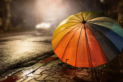 Umbrella on wet street during rainy season