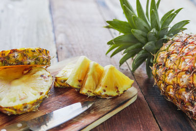 Close-up of fruits and leaves on cutting board