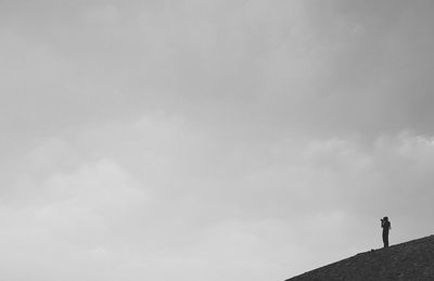 Silhouette of woman against clear sky