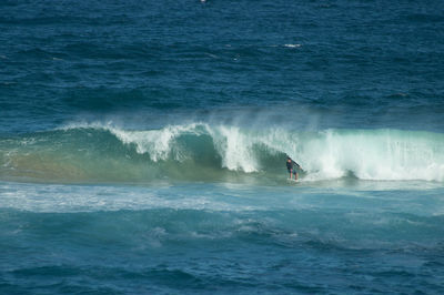 People surfing in sea