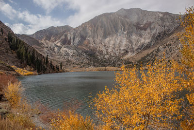 Scenic view of lake by mountains against sky. convict lake, ca