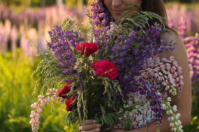 Close-up of woman holding flower bouquet