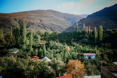 Scenic view of village among mountains 