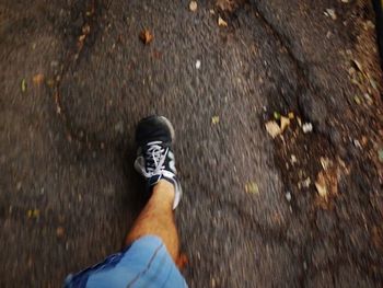 Low section of person standing on tiled floor