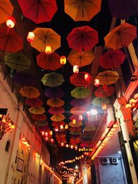 Low angle view of illuminated lanterns hanging at night