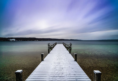 Pier over lake against sky