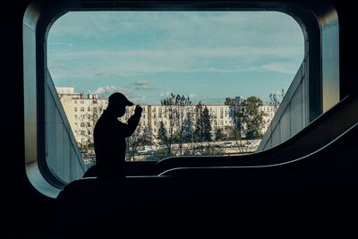 Silhouette man seen through car window