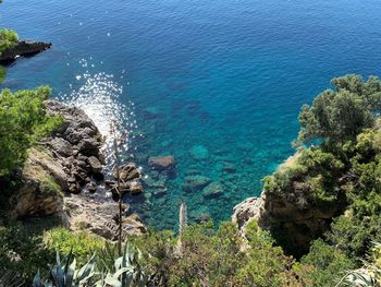 High angle view of rocks by sea