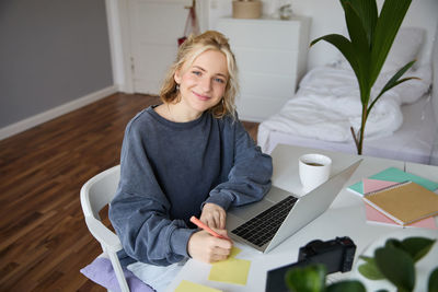 Portrait of young woman using digital tablet