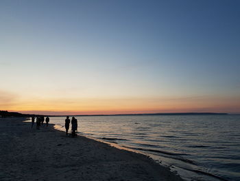 Scenic view of beach against sky during sunset