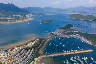 Aerial view of sea and mountains against sky