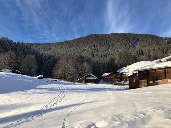 Snow covered landscape against sky