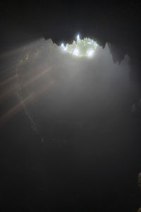 High angle view of illuminated lake against sky at night