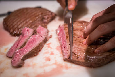 Close-up of person preparing food on table