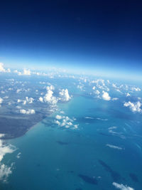 Aerial view of sea against blue sky