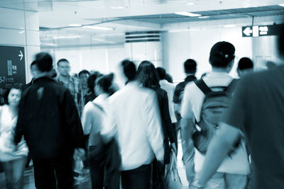 Rear view of people walking in corridor