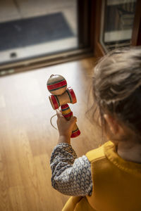 High angle view of girl holding toy at home