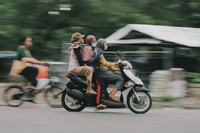 People riding bicycle on road