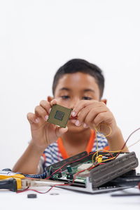 Portrait of boy holding toy car