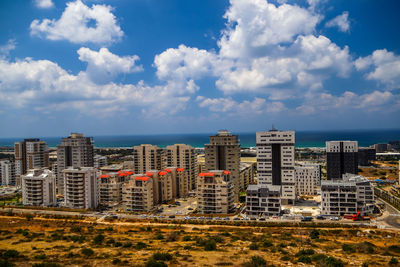Modern buildings in city against sky