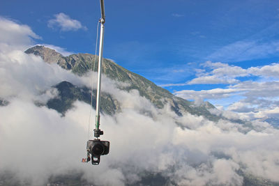 Low angle view of overhead cable cars against sky