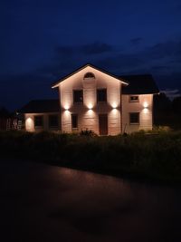 Illuminated building against sky at night