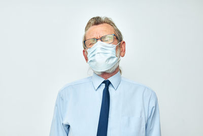 Man wearing mask against white background