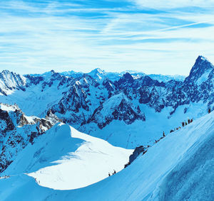 Scenic view of snow covered mountains against sky