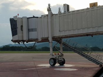 Motorcycle on airport runway against sky