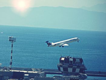 Seagull flying over sea against sky