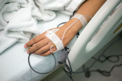 Cropped image of patient with iv drip at hospital