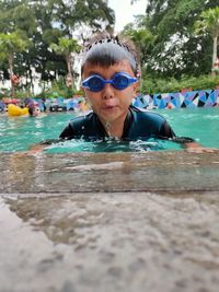 Boys swimming using swimming goggles