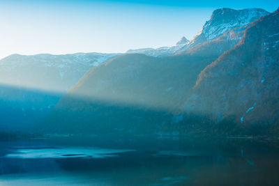 Scenic view of sea against mountain during winter