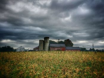 Scenic view of field against cloudy sky