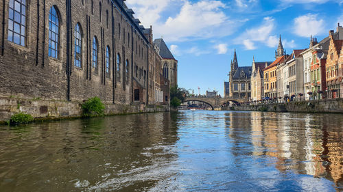 Canal passing through buildings in city