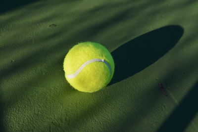 Close-up of tennis ball on sports court